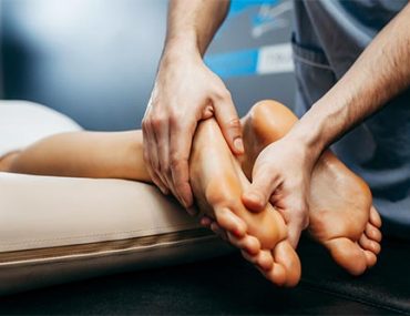 the-doctor-podiatrist-does-an-examination-and-massage-of-the-patient-s-foot-in-the-clinic
